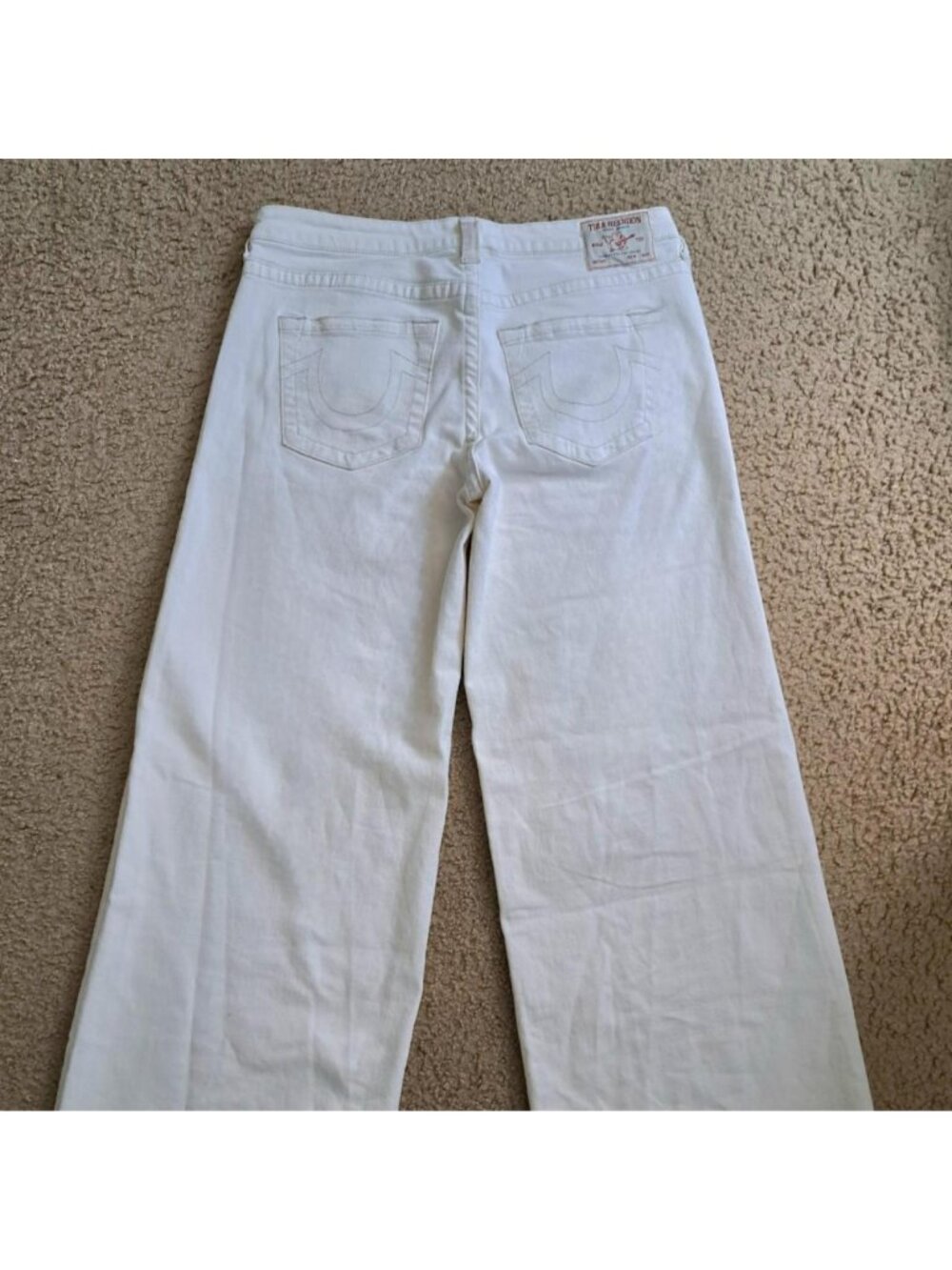 white True Religion denim high waisted wide leg jeans with distressed hem